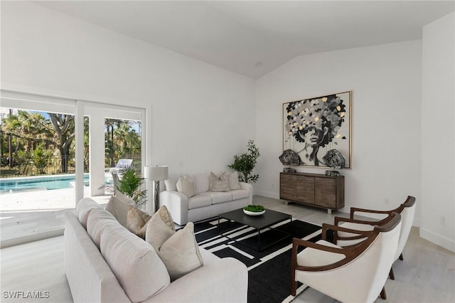 living room with lofted ceiling and baseboards