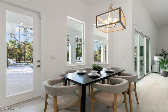 dining room featuring light wood-style flooring and a chandelier