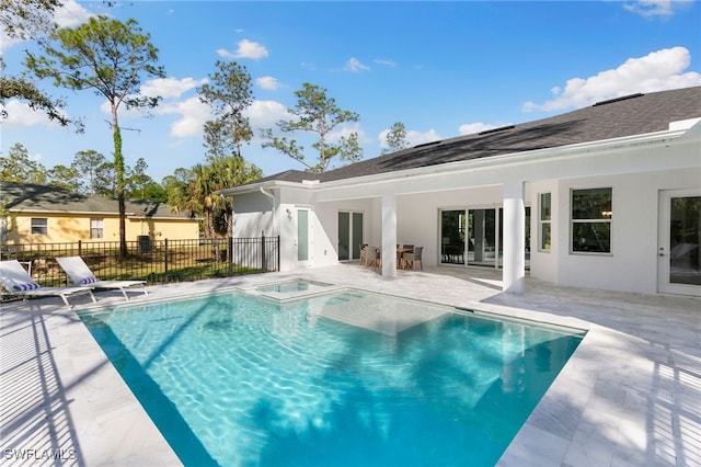 view of pool with fence, a patio, and an in ground hot tub