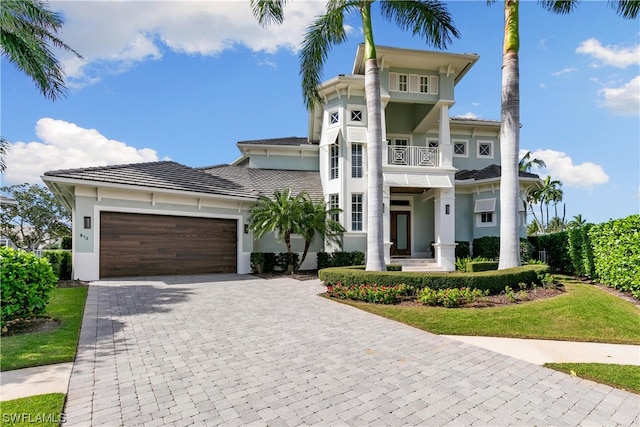 view of front of property featuring a balcony and a garage