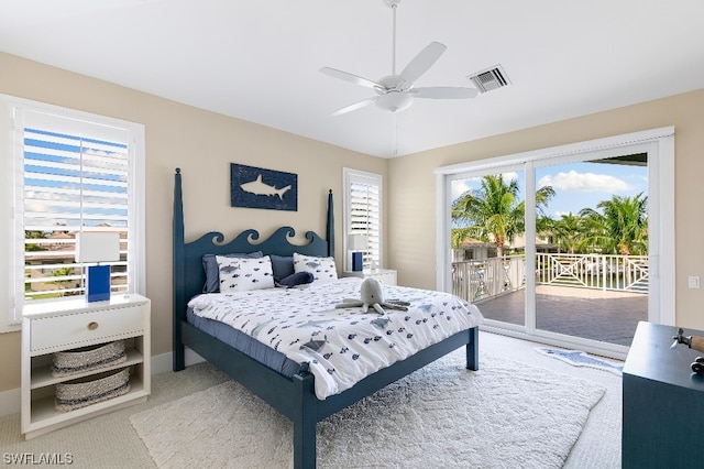 carpeted bedroom featuring ceiling fan, access to outside, and multiple windows