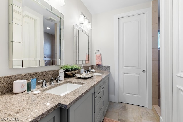 bathroom with tile floors, double sink, and vanity with extensive cabinet space