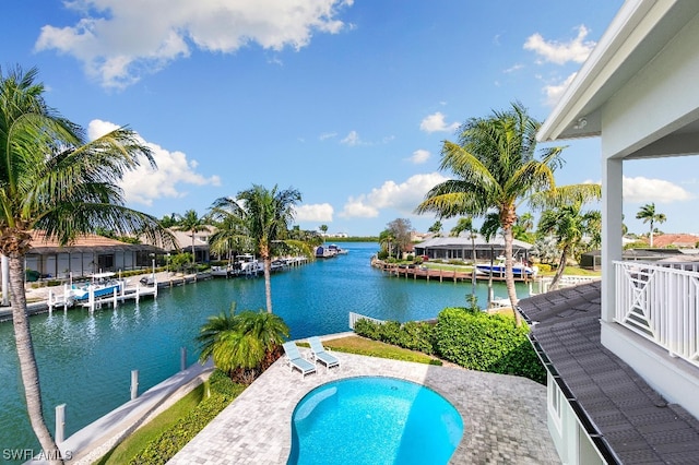 view of pool featuring a water view and a boat dock