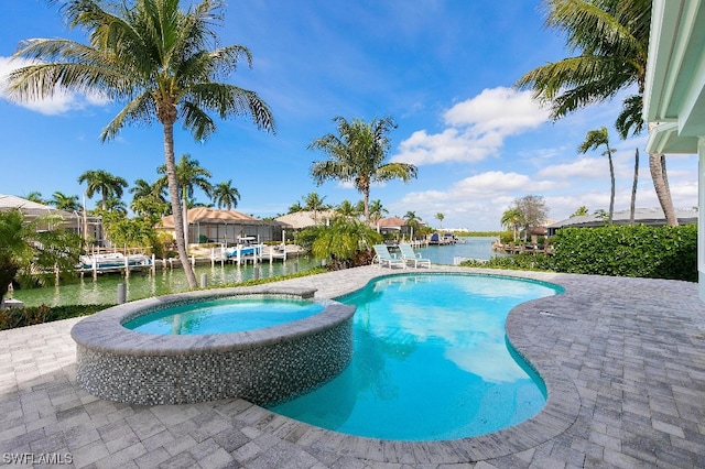 view of swimming pool featuring an in ground hot tub, a dock, a patio, and a water view