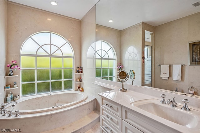 bathroom featuring a relaxing tiled bath and oversized vanity