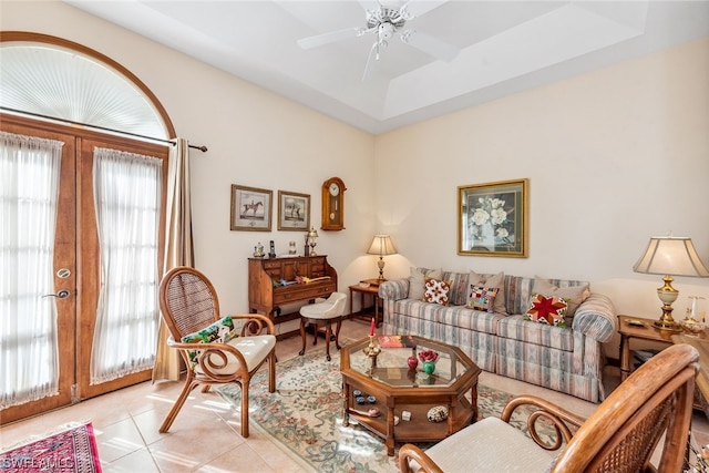 tiled living room with a raised ceiling, ceiling fan, french doors, and a wealth of natural light