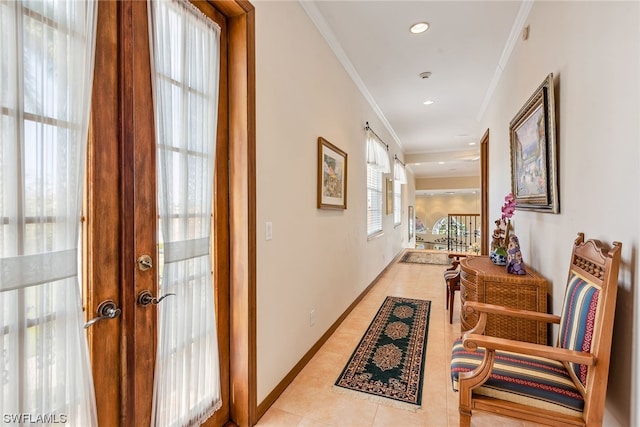 hallway featuring light tile flooring and ornamental molding