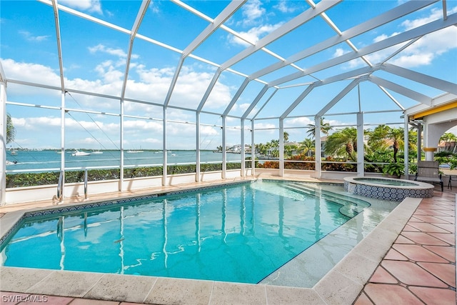 view of swimming pool with a patio area, an in ground hot tub, and glass enclosure