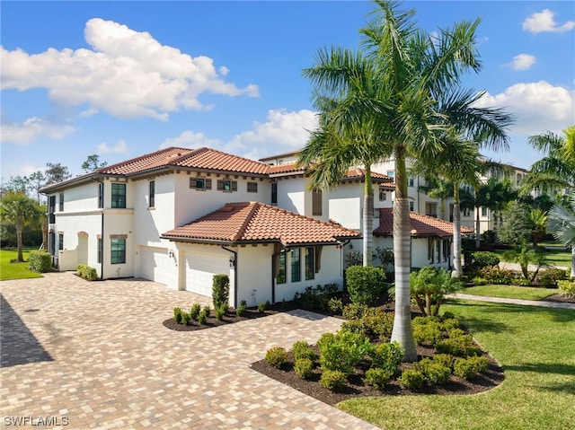 mediterranean / spanish house with a front yard