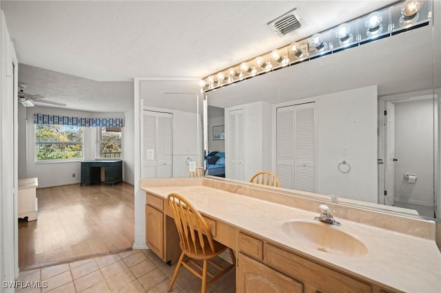 bathroom featuring vanity, tile patterned floors, and ceiling fan