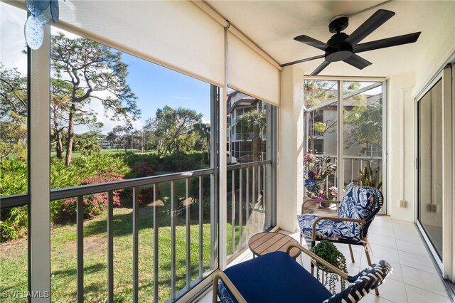 sunroom featuring ceiling fan and plenty of natural light