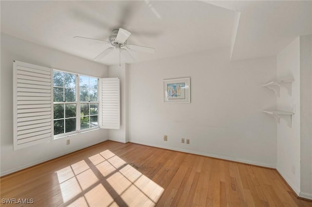 empty room featuring ceiling fan and light hardwood / wood-style floors