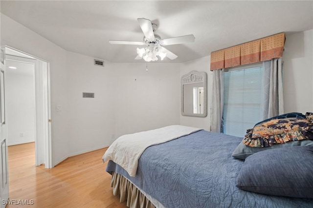 bedroom with wood-type flooring and ceiling fan