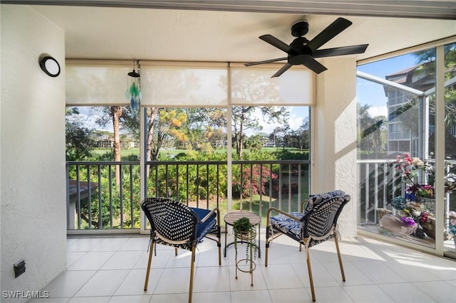 sunroom / solarium featuring ceiling fan