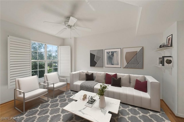 living room featuring wood-type flooring and ceiling fan