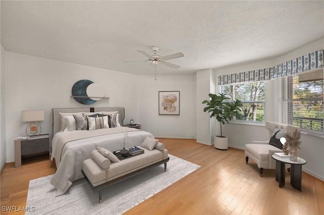 bedroom featuring ceiling fan and light hardwood / wood-style flooring