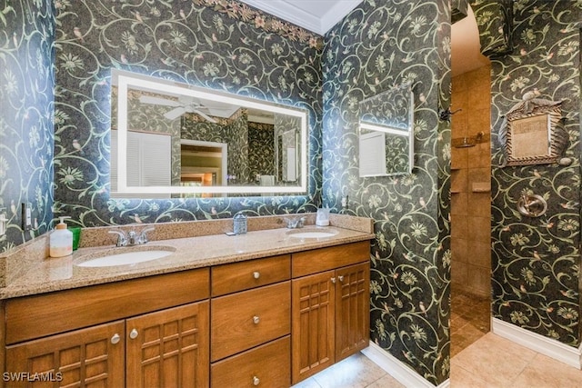 bathroom with tile patterned flooring, vanity, and crown molding