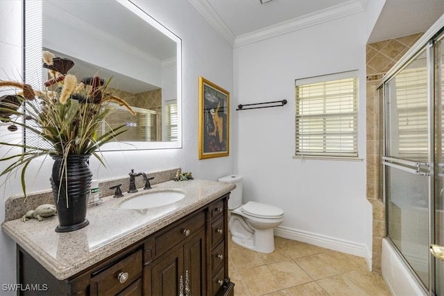 full bathroom featuring vanity, tile patterned floors, toilet, ornamental molding, and enclosed tub / shower combo