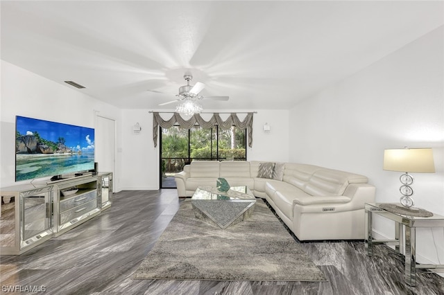 living room with ceiling fan and dark wood-type flooring