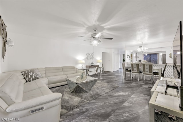 living room with ceiling fan with notable chandelier