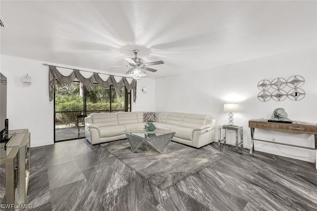 living room with baseboards and a ceiling fan