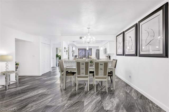 dining room featuring a chandelier, visible vents, and baseboards