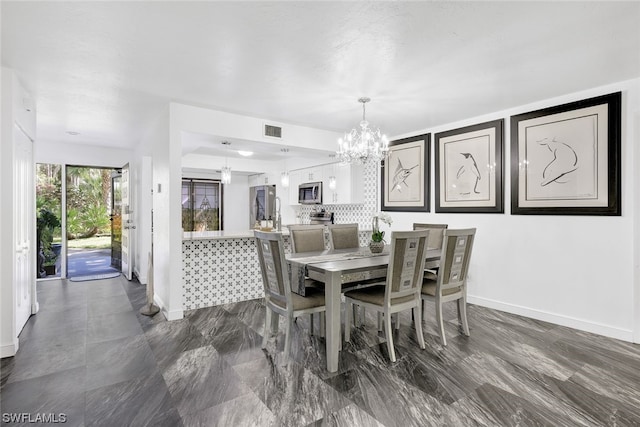 dining area featuring visible vents, baseboards, and an inviting chandelier