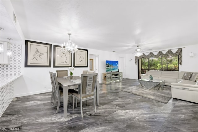 dining room with ceiling fan with notable chandelier and baseboards