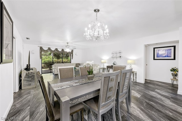 dining space with visible vents, baseboards, dark wood-style floors, and ceiling fan with notable chandelier