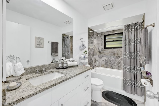 full bath featuring vanity, toilet, marble finish floor, and shower / tub combo with curtain