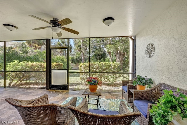 sunroom featuring ceiling fan