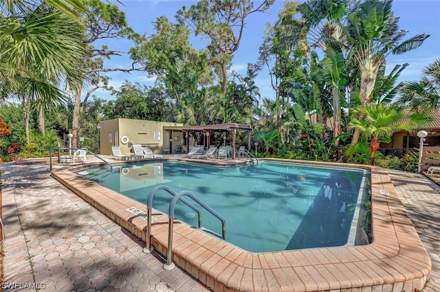 pool featuring a patio and a pergola