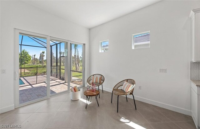 living area with plenty of natural light and light tile patterned flooring