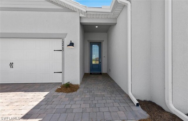 view of exterior entry featuring a garage