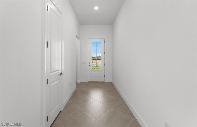 doorway featuring light tile patterned flooring