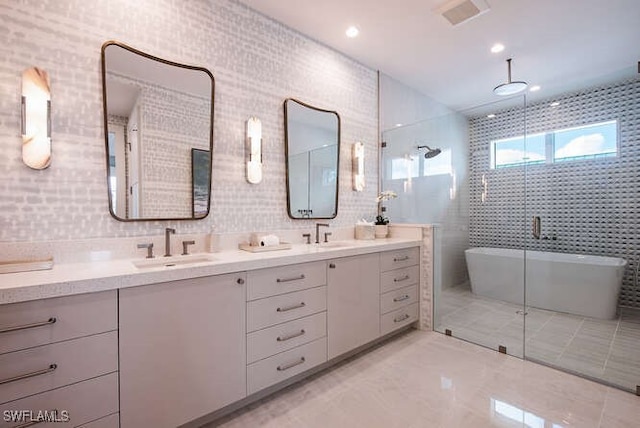 bathroom with vanity, tile walls, and shower with separate bathtub