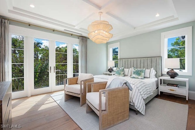 bedroom with access to outside, light hardwood / wood-style flooring, and multiple windows