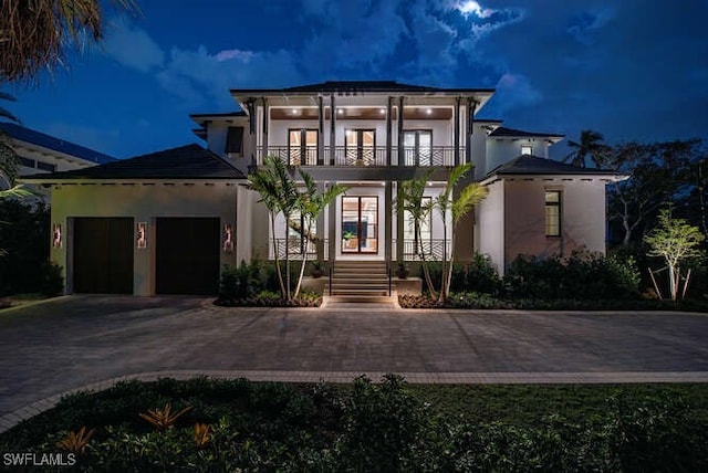 view of front of property with french doors and a balcony