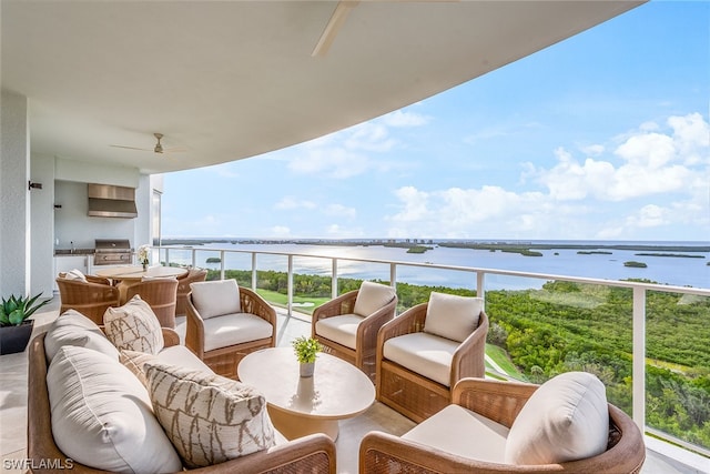 balcony with ceiling fan and a water view