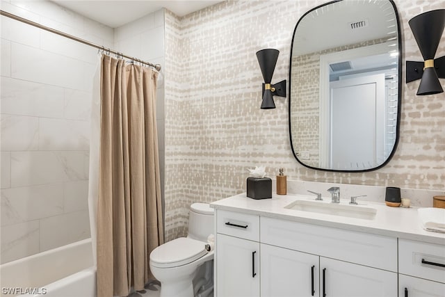 full bathroom with shower / bath combo, vanity with extensive cabinet space, and toilet