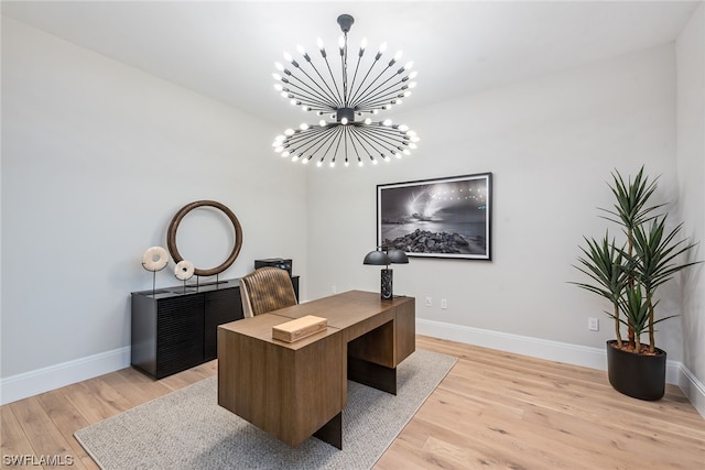 home office featuring an inviting chandelier and light hardwood / wood-style floors