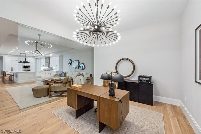 home office featuring light wood-type flooring and a chandelier