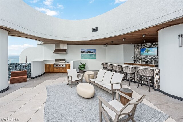 interior space with light tile flooring and a water view