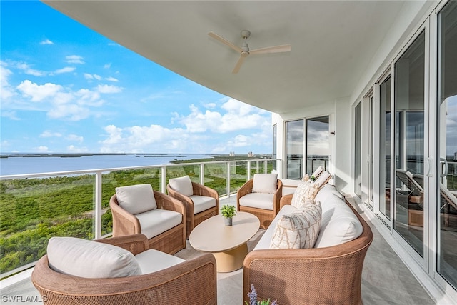 balcony featuring an outdoor hangout area, a water view, and ceiling fan