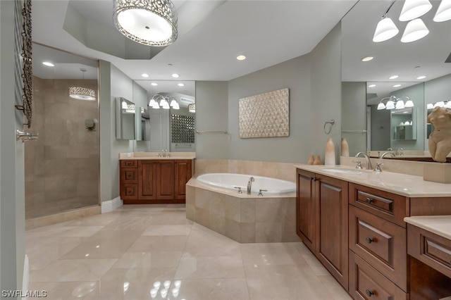 bathroom featuring vanity and shower with separate bathtub