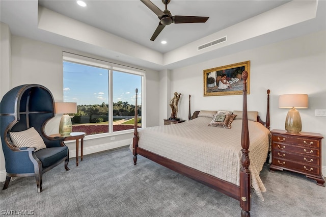 bedroom featuring carpet flooring, ceiling fan, and a tray ceiling