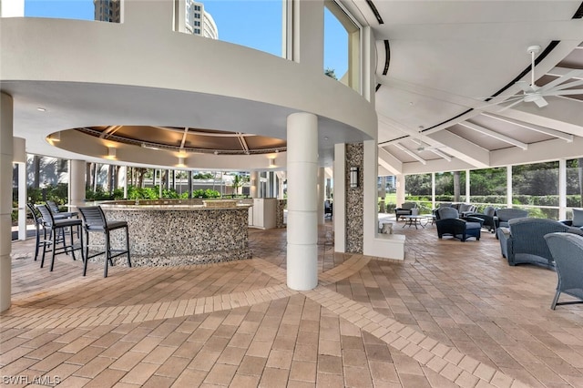 view of patio / terrace with exterior bar, an outdoor hangout area, and ceiling fan