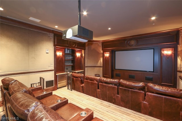 cinema with crown molding and hardwood / wood-style flooring