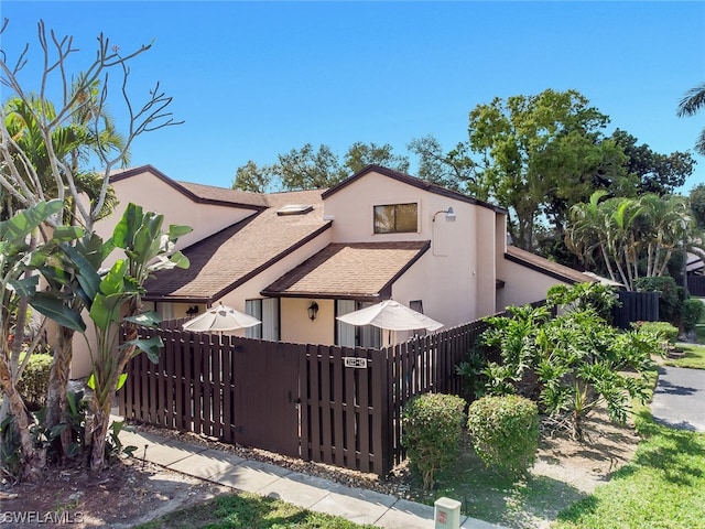 exterior space featuring a fenced front yard and stucco siding