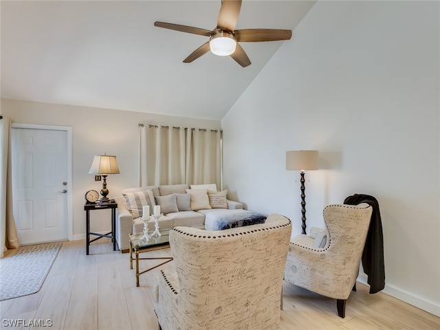 living room featuring high vaulted ceiling, ceiling fan, and light wood-type flooring